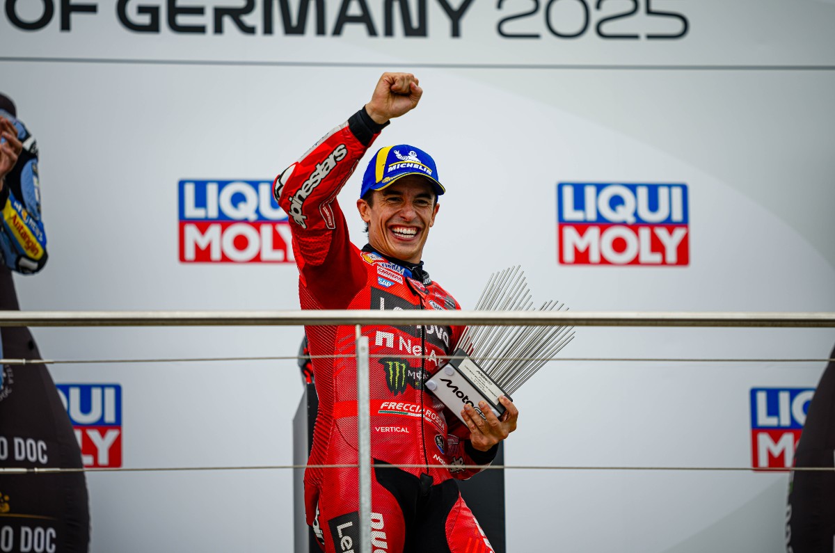 Marc Marquez wins 2025 German MotoGP race, celebrating on podium
